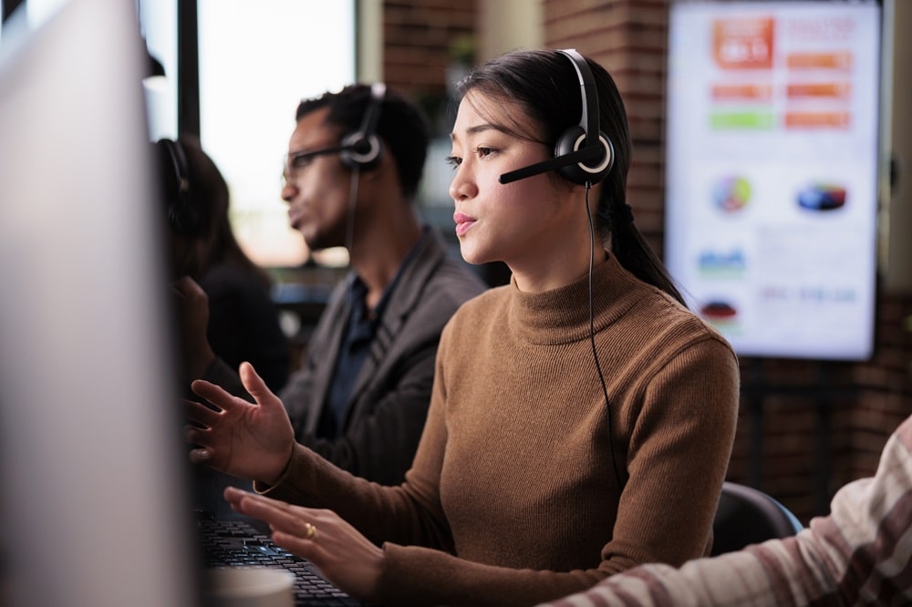 sales consultant using remote telecommunication assistance in office.